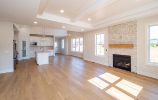 long view of open living area with fireplace and kitchen in background