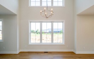 gold chandelier in open room with high ceiling