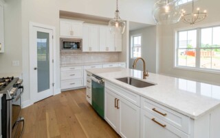 kitchen island with metal fixture and hanging glass lights and chandelier