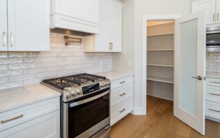 kitchen with stainless oven and large pantry