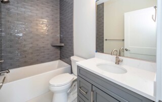 bathroom with grey tiled shower