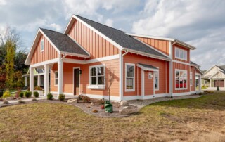 corner view of new home with landscaping on bright day