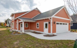 orange home with new concrete driveway and sidewalk