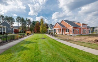striking cloudy sky over green lawn with orange house and neighborhood