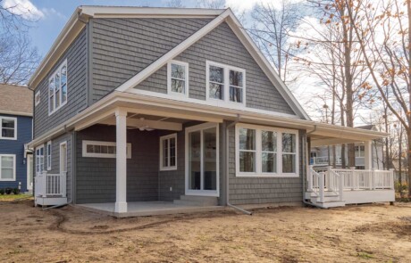 two story grey house with shake style siding