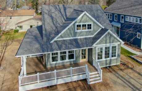 high view of new home with wraparound porch