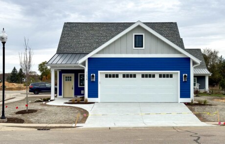 finished view of garage door and driveway