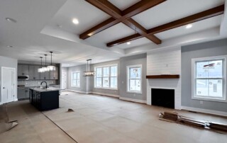 open living area with inset wooden beams in ceiling