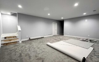 large basement room with carpet being installed