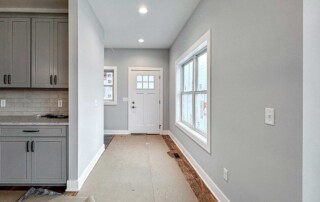 hallway leading to exterior door in bright home