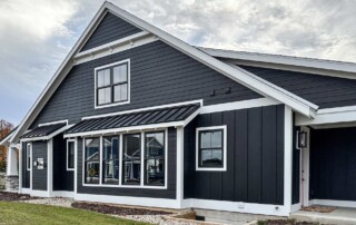 exterior view of roof peak and many windows on side of home