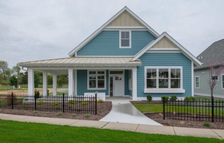 front of blue home with yellow accents