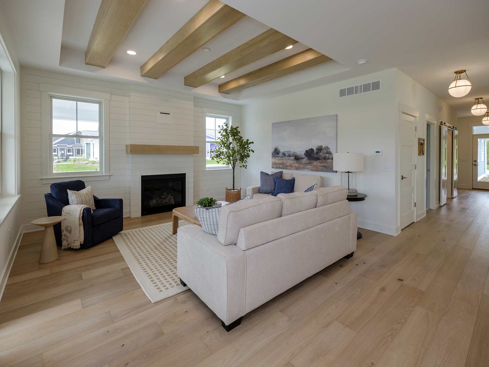 open interior with wood flooring and white couch