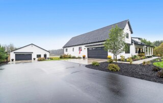 white custom home and additional building with black accents