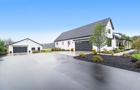white custom home and additional building with black accents