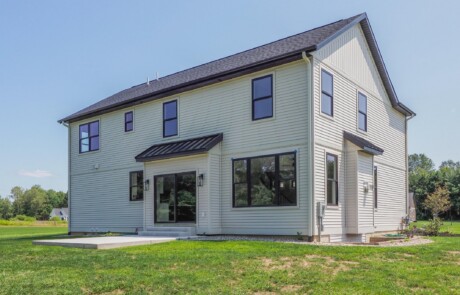 back of two story white home
