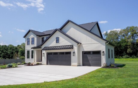 garage view of two story white home