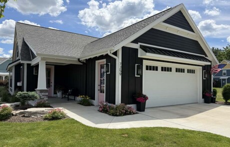angled view of garage and driveway of black home