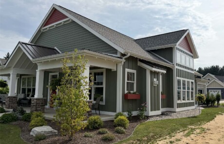 upward angled view of greyish home with burnt orange accent