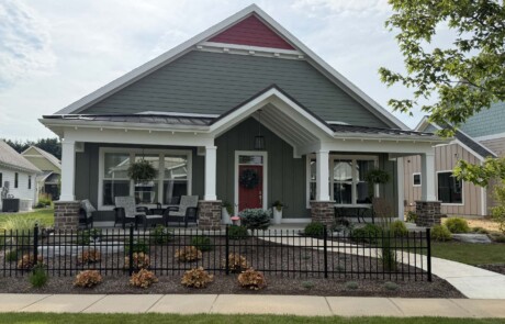 front entrance view of greyish home with burnt orange accent
