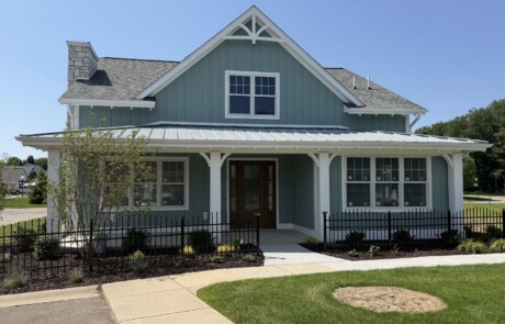 blue-green home with long porch