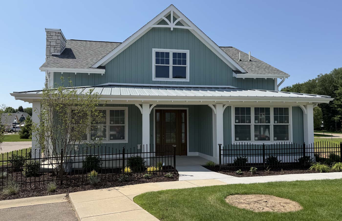 blue-green home with long porch