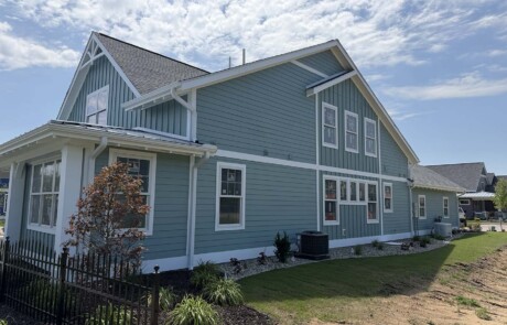 greenish home with two stories