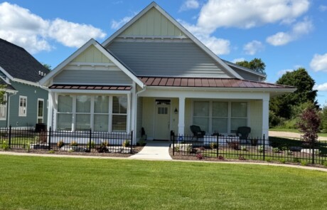 front elevation view of green and yellow home